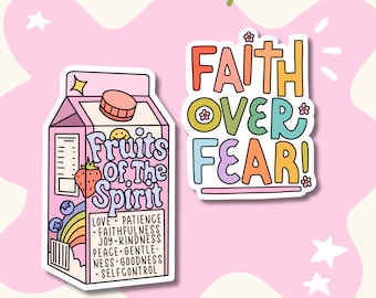 May include: Two die-cut stickers. One is a pink milk carton labeled Fruits of the Spirit with a strawberry, rainbow, and a list of virtues. The other is a multi-colored sticker with the text Faith Over Fear in a bold, rounded font with small flower accents.