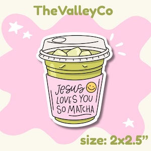 May include: A die-cut sticker of a green matcha iced drink in a clear plastic cup with a lid. A pink sleeve features the text 'Jesus LOVES YOU SO MATCHA' with a yellow smiley face. The sticker measures 2 inches by 2.5 inches.