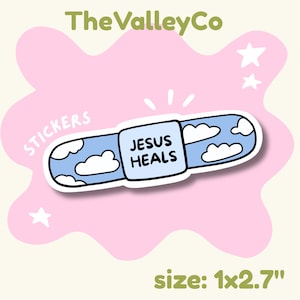 May include: A rectangular adhesive bandage sticker featuring a light blue sky pattern with white clouds and the text JESUS HEALS in black capital letters on the center pad. The sticker measures 1 inch by 2.7 inches and includes the text TheValleyCo.