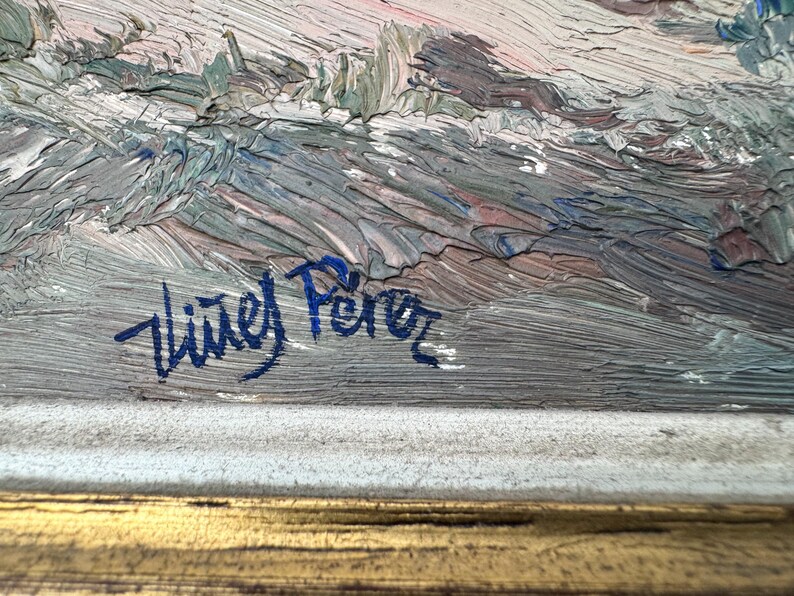 May include: An impressionistic landscape painting with thick brushstrokes in shades of gray, blue, and pink. The artist's signature, "Vi&ntilde;es P&eacute;rez," is visible in blue. The painting is framed in a gold-colored frame.