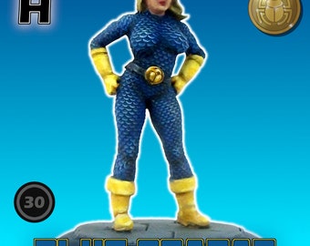 May include: A blue and yellow painted miniature figure of a female superhero standing on a black base. The figure is wearing a blue suit with yellow accents and a blue mask. The base has the words "BLUE SCARAB" written on it in blue and yellow letters. The figure is labeled "H" and has a number "30" on a blue circle.