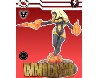 May include: A miniature figurine of a female superhero, with blonde hair and a black and yellow bodysuit, stands on a fiery base. The figure is holding flames in each hand. The word "IMMOLATOR" is displayed in gold lettering. The background is red.