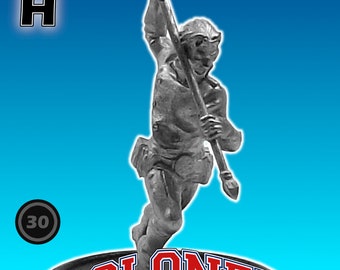 May include: A gray plastic miniature figure of a person holding a torch, standing on a black base with the words "COLONEL GLORY" in red and blue letters. The figure is labeled "H" and "30".
