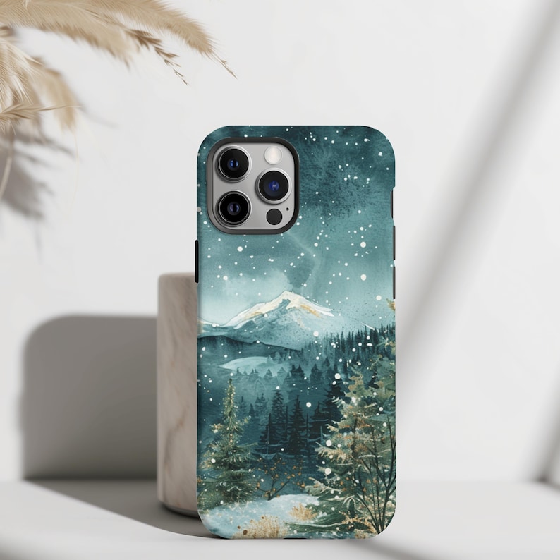 Winter mountain landscape phone case with snowy forest scene, available in tough and magnetic tough models for iPhone and Samsung