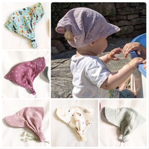 May include: A set of five different fabric baby hats. The hats are all made of a soft, breathable fabric and have a variety of colors and patterns. The hats are perfect for keeping a baby's head warm and protected from the sun.