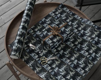 May include: A roll of black and white patterned wrapping paper, a wrapped gift with a brown ribbon, and a sheet of wrapping paper with scissors on a wooden table. The pattern features a repeating design of stylized trees.