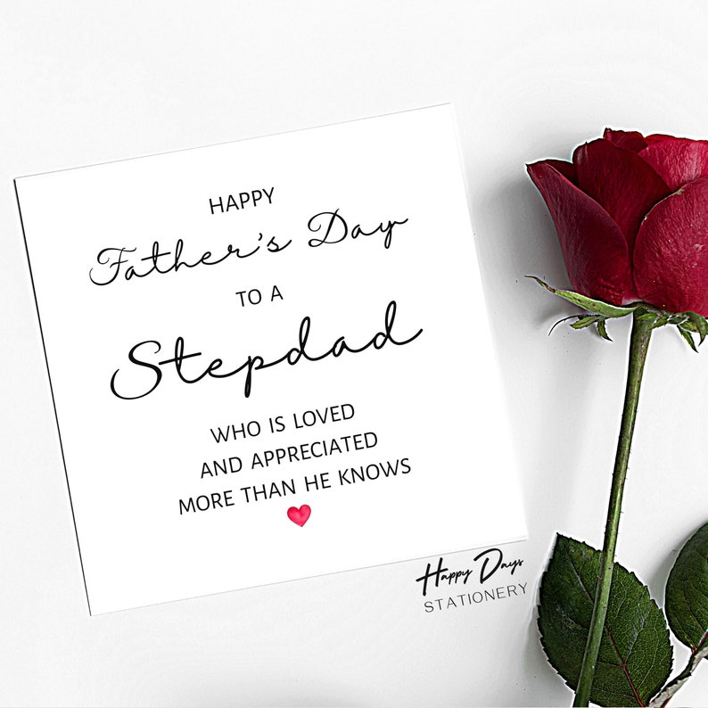May include: A white card with black text that reads "Happy Father's Day to a Stepdad who is loved and appreciated more than he knows". A red heart is below the text. The card is on a white background with a red rose in the corner.