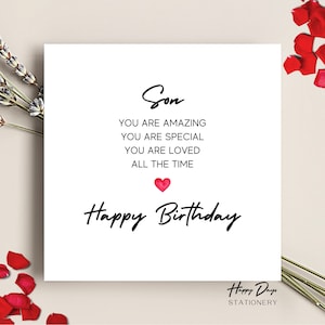 May include: A white card with black text that reads "Son You are amazing You are special You are loved All the time Happy Birthday" with a red heart graphic. The card has a "Happy Days Stationery" logo at the bottom.