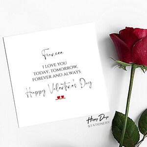 May include: A white card with black text that reads "Fianc&eacute;e I LOVE YOU TODAY, TOMORROW, FOREVER AND ALWAYS Happy Valentine's Day" with two red hearts. The card is on a white background with a red rose in the corner.