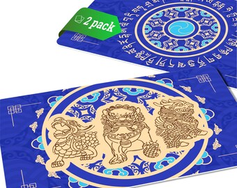 May include: Two blue and gold decorative coasters with a circular design featuring three mythical creatures. The coasters have a repeating pattern of stylized clouds and a border of Tibetan script.