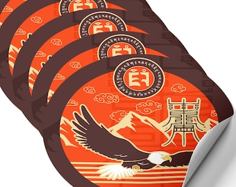 May include: A set of six round stickers featuring a stylized eagle flying over a mountain range with a red and orange background. The eagle is brown and black. The stickers have a brown border and a white outline. The stickers also feature a circular design with a Tibetan symbol and text in Tibetan script.