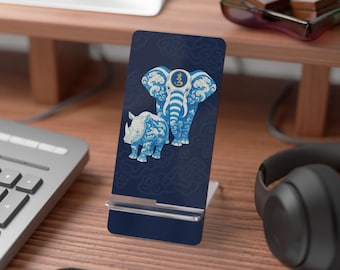 May include: A navy blue phone stand featuring a blue and white elephant and rhinoceros design. The animals are decorated with wave and cloud patterns. The stand is on a wooden desk.
