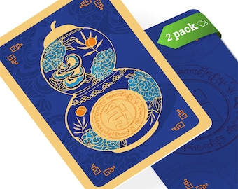 May include: Two playing cards with a blue background and gold trim. One card features a gourd design with floral and coin details. The other card has a green "2 pack" label. The cards have a decorative, ornate style.