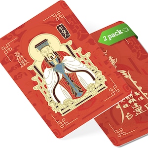 May include: Two red cards with a gold illustration of a man in traditional attire. The cards have decorative patterns and Chinese characters. One card has a green "2 pack" label.