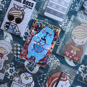 May include: A collection of colourful stickers featuring cartoon characters and designs. The stickers are in clear plastic sleeves, perfect for organising and displaying.