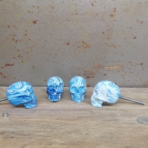 May include: Four blue and white skull-shaped drawer pulls with silver screws.