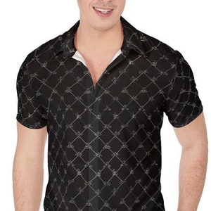 May include: A black short-sleeved button-down shirt with a white geometric pattern. The shirt has a collared neckline and a button closure.