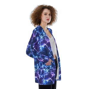 May include: A long-sleeved cardigan with a blue and purple lightning bolt pattern. The cardigan has a V-neck and pockets.