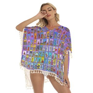 May include: A purple and blue beach cover-up with a white fringe trim. The cover-up features a pattern of tarot cards.