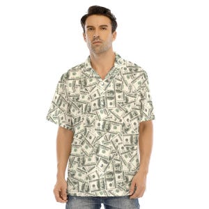 May include: A short-sleeved button-up shirt with a white background and a pattern of US dollar bills. The shirt has a collared neckline and a relaxed fit.