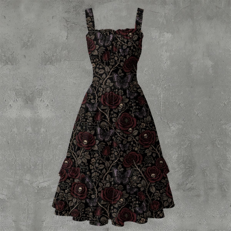 May include: A black midi dress featuring a repeating pattern of dark red roses, butterflies, and small skulls on a vine-like background. The dress has a square neckline, thick shoulder straps, and a tiered skirt with a ruffled hemline.