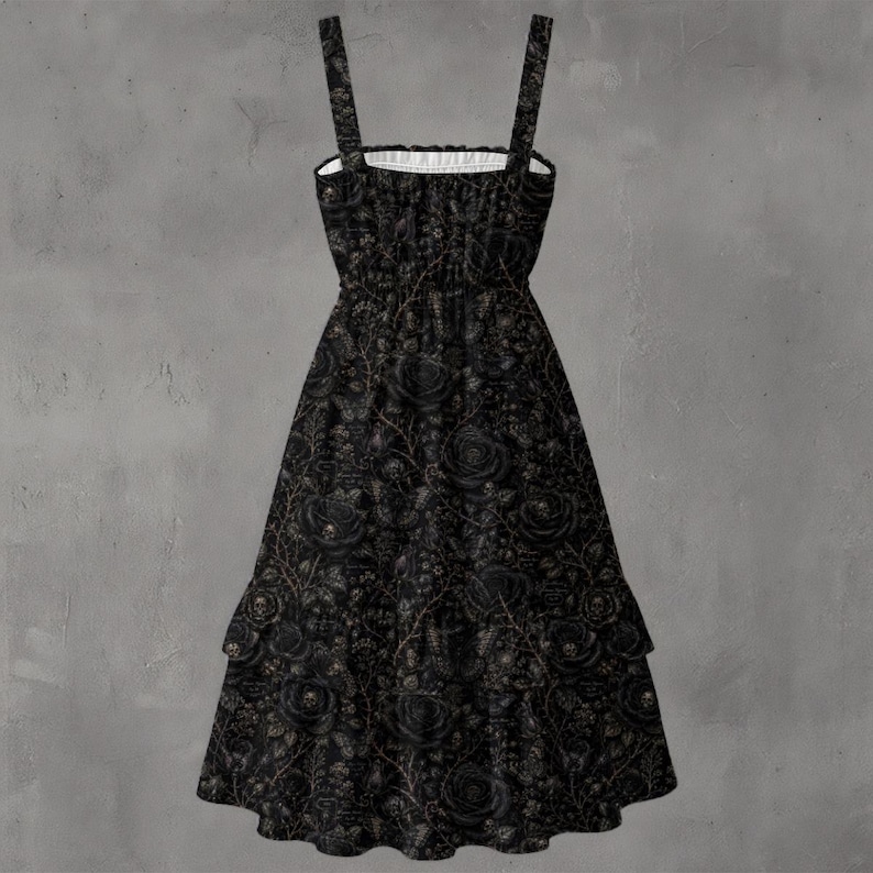 May include: A black midi dress featuring a square neckline, thick shoulder straps, and a smocked bodice. The fabric is adorned with an intricate, repeating pattern of dark roses, thorny vines, and small skulls throughout the entire garment.