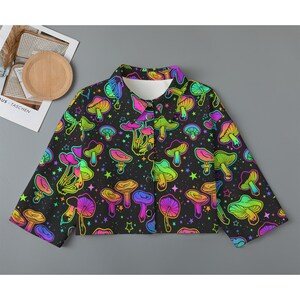 May include: A black cropped jacket with a rainbow mushroom print and stars. The jacket has a button closure and long sleeves.
