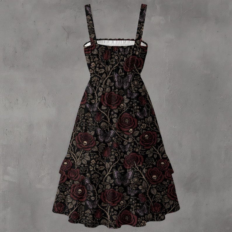 May include: A sleeveless midi dress featuring a black background with a repeating pattern of dark red roses, small skulls nestled within the flowers, and butterflies. The dress has a square neckline, thick shoulder straps, and a tiered skirt.