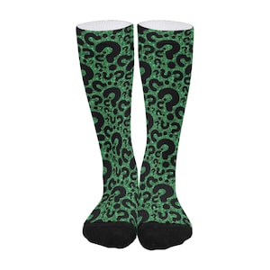 May include: A pair of green and black knee-high socks with a question mark pattern.