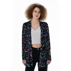 May include: A black cardigan featuring a colourful cat and star pattern. The cardigan has long sleeves and a relaxed fit.