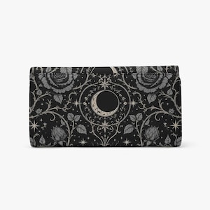 May include: A rectangular wallet featuring a black background with a repeating pattern of grey roses, thorny vines, and stars. A central circular motif displays a crescent moon surrounded by intricate filigree and small starburst accents.