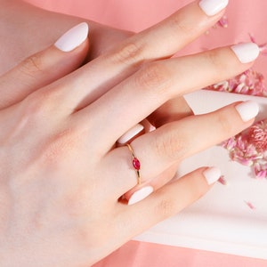 Here is marquise ruby ring 14K solid gold ruby stackable ring. Our marquise-cut ruby birthstone ring will be perfect gift for women. Solo red ruby ring can be customized with your birthstone. Are you looking for ruby ring 14K gold and ruby stacking ring, here is the dainty ruby ring and single stone ring for your self. Discover our minimalist ruby ring and red and yellow rings as a mothers day gifts.