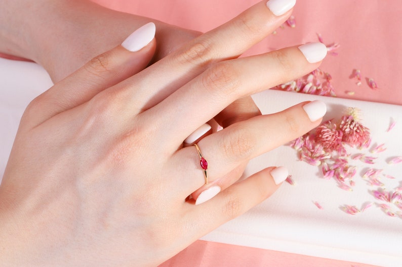 Here is marquise ruby ring 14K solid gold ruby stackable ring. Our marquise-cut ruby birthstone ring will be perfect gift for women. Solo red ruby ring can be customized with your birthstone. Are you looking for ruby ring 14K gold and ruby stacking ring, here is the dainty ruby ring and single stone ring for your self. Discover our minimalist ruby ring and red and yellow rings as a mothers day gifts.