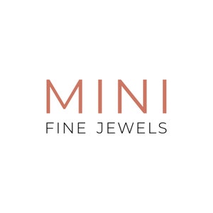 May include: The logo for Mini Fine Jewels features the word "MINI" in a terracotta color, stacked above the words "FINE JEWELS" in a thin, black font. The background is plain white.