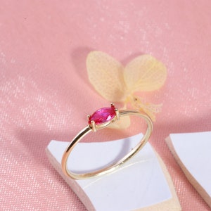 Here is marquise ruby ring 14K solid gold ruby stackable ring. Our marquise-cut ruby birthstone ring will be perfect gift for women. Solo red ruby ring can be customized with your birthstone. Are you looking for ruby ring 14K gold and ruby stacking ring, here is the dainty ruby ring and single stone ring for your self. Discover our minimalist ruby ring and red and yellow rings as a mothers day gifts.