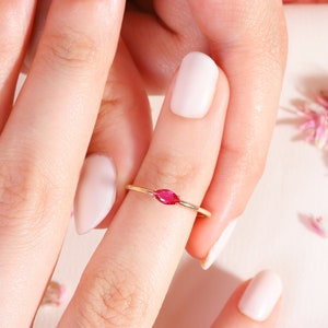 Here is marquise ruby ring 14K solid gold ruby stackable ring. Our marquise-cut ruby birthstone ring will be perfect gift for women. Solo red ruby ring can be customized with your birthstone. Are you looking for ruby ring 14K gold and ruby stacking ring, here is the dainty ruby ring and single stone ring for your self. Discover our minimalist ruby ring and red and yellow rings as a mothers day gifts.