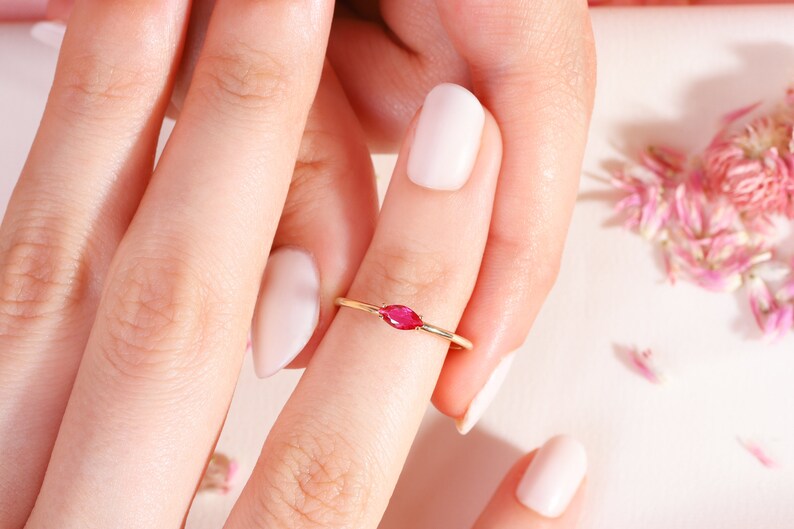 Here is marquise ruby ring 14K solid gold ruby stackable ring. Our marquise-cut ruby birthstone ring will be perfect gift for women. Solo red ruby ring can be customized with your birthstone. Are you looking for ruby ring 14K gold and ruby stacking ring, here is the dainty ruby ring and single stone ring for your self. Discover our minimalist ruby ring and red and yellow rings as a mothers day gifts.