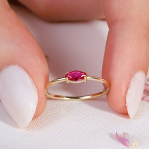 Here is marquise ruby ring 14K solid gold ruby stackable ring. Our marquise-cut ruby birthstone ring will be perfect gift for women. Solo red ruby ring can be customized with your birthstone. Are you looking for ruby ring 14K gold and ruby stacking ring, here is the dainty ruby ring and single stone ring for your self. Discover our minimalist ruby ring and red and yellow rings as a mothers day gifts.