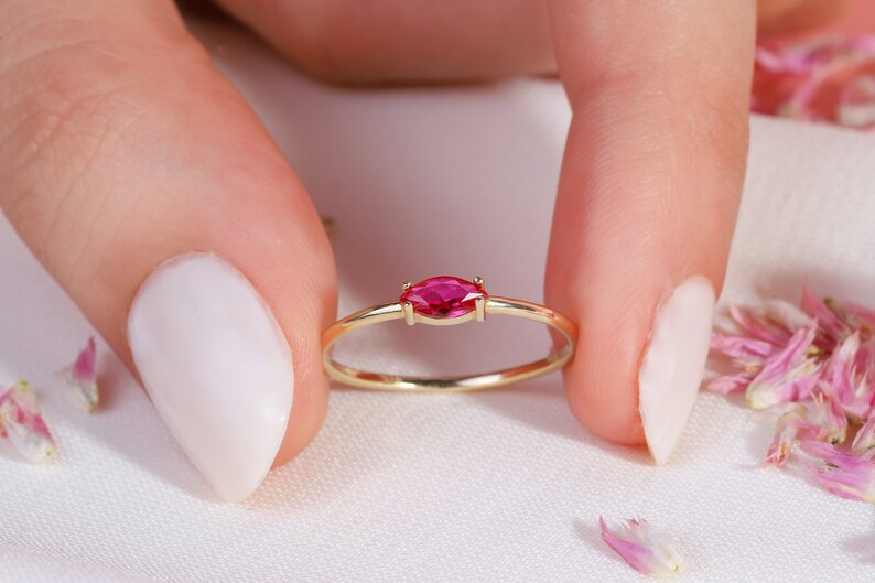 Here is marquise ruby ring 14K solid gold ruby stackable ring. Our marquise-cut ruby birthstone ring will be perfect gift for women. Solo red ruby ring can be customized with your birthstone. Are you looking for ruby ring 14K gold and ruby stacking ring, here is the dainty ruby ring and single stone ring for your self. Discover our minimalist ruby ring and red and yellow rings as a mothers day gifts.