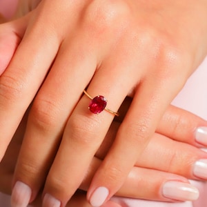 Here’s Ruby Wedding Anniversary Ring for Valentine. Our Customized Pinky Gemstone Oval Engagement Ring is use as 14K gold ruby ring for her wedding shower. 10K 14K 18K Gold Personalized Birthstone Proposal Jewelry looks like mindful Gift for her.