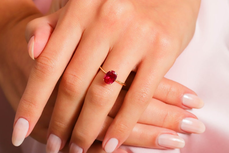 Here’s Ruby Wedding Anniversary Ring for Valentine. Our Customized Pinky Gemstone Oval Engagement Ring is use as 14K gold ruby ring for her wedding shower. 10K 14K 18K Gold Personalized Birthstone Proposal Jewelry looks like mindful Gift for her.