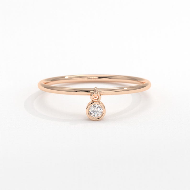 💎 Diamond Dangle Ring – Minimalist 14K Solid Gold Gift for Her
Add effortless sparkle to your everyday style with this diamond dangle ring – a dainty and elegant piece crafted in your choice of 10K, 14K, or 18K solid gold. Featuring a single round-cut diamond or moissanite, this delicate dangling diamond ring brings movement, brilliance, and charm to any look.

Perfect for women who love minimalist jewelry, this handmade gold ring makes a beautiful statement whether worn alone or stacked.