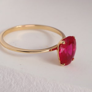 Here’s Ruby Wedding Anniversary Ring for Valentine. Our Customized Pinky Gemstone Oval Engagement Ring is use as 14K gold ruby ring for her wedding shower. 10K 14K 18K Gold Personalized Birthstone Proposal Jewelry looks like mindful Gift for her.