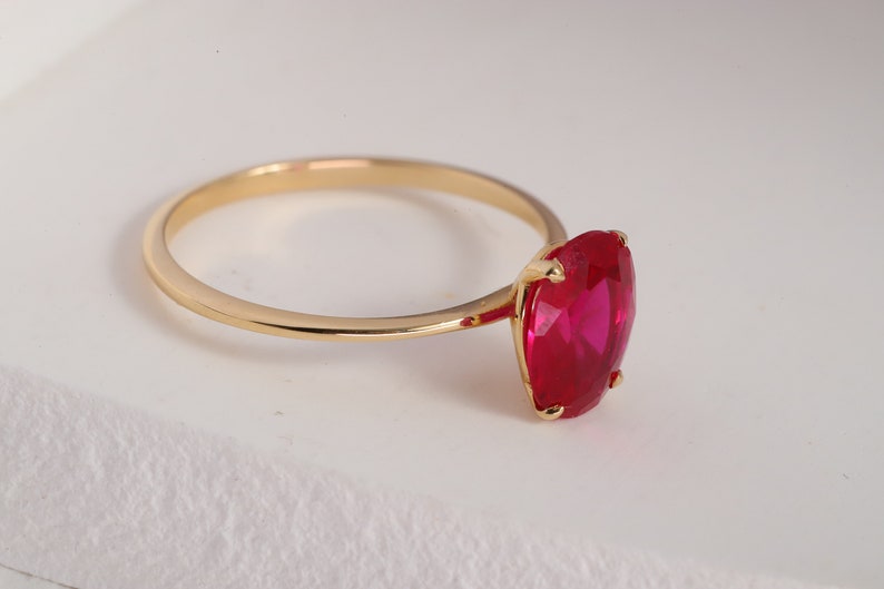 Here’s Ruby Wedding Anniversary Ring for Valentine. Our Customized Pinky Gemstone Oval Engagement Ring is use as 14K gold ruby ring for her wedding shower. 10K 14K 18K Gold Personalized Birthstone Proposal Jewelry looks like mindful Gift for her.