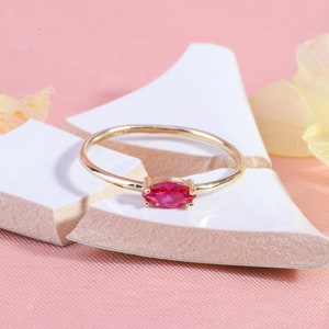 Here is marquise ruby ring 14K solid gold ruby stackable ring. Our marquise-cut ruby birthstone ring will be perfect gift for women. Solo red ruby ring can be customized with your birthstone. Are you looking for ruby ring 14K gold and ruby stacking ring, here is the dainty ruby ring and single stone ring for your self. Discover our minimalist ruby ring and red and yellow rings as a mothers day gifts.