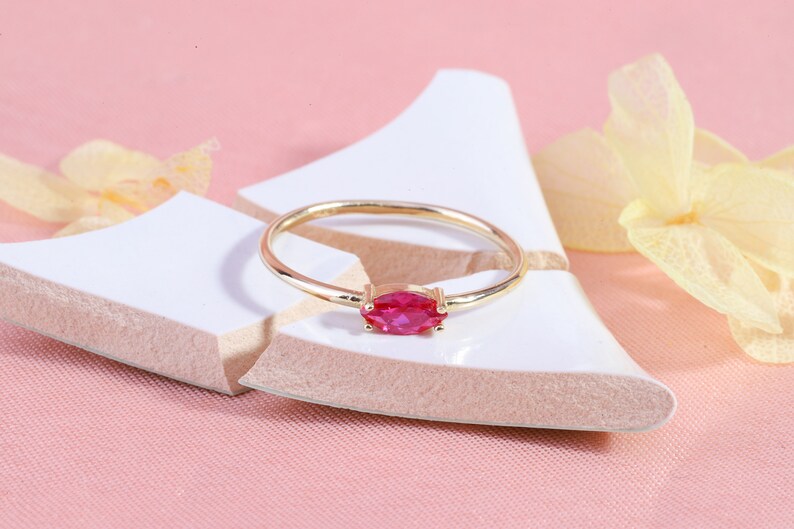 Here is marquise ruby ring 14K solid gold ruby stackable ring. Our marquise-cut ruby birthstone ring will be perfect gift for women. Solo red ruby ring can be customized with your birthstone. Are you looking for ruby ring 14K gold and ruby stacking ring, here is the dainty ruby ring and single stone ring for your self. Discover our minimalist ruby ring and red and yellow rings as a mothers day gifts.