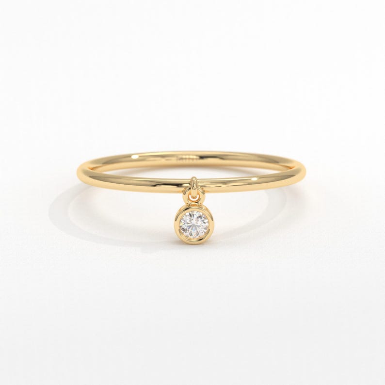 💎 Diamond Dangle Ring – Minimalist 14K Solid Gold Gift for Her
Add effortless sparkle to your everyday style with this diamond dangle ring – a dainty and elegant piece crafted in your choice of 10K, 14K, or 18K solid gold. Featuring a single round-cut diamond or moissanite, this delicate dangling diamond ring brings movement, brilliance, and charm to any look.

Perfect for women who love minimalist jewelry, this handmade gold ring makes a beautiful statement whether worn alone or stacked.