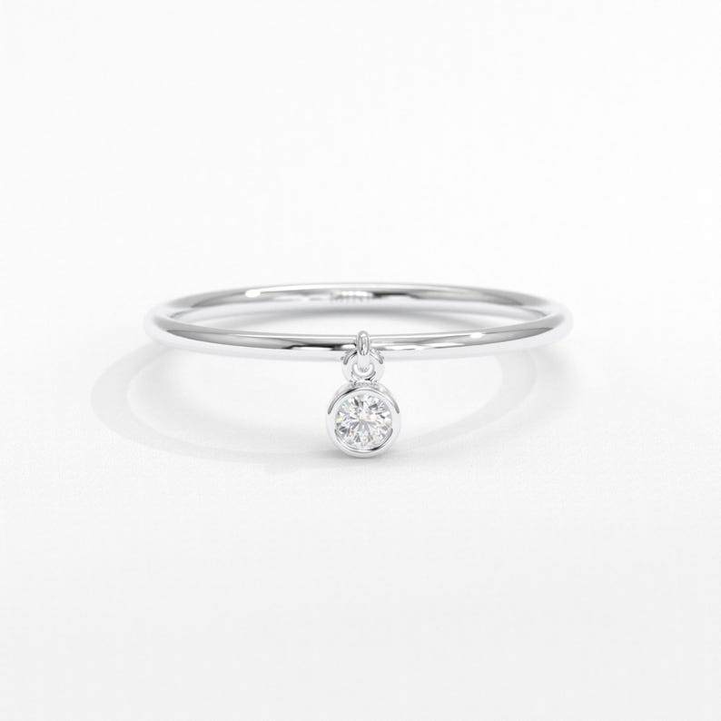 💎 Diamond Dangle Ring – Minimalist 14K Solid Gold Gift for Her
Add effortless sparkle to your everyday style with this diamond dangle ring – a dainty and elegant piece crafted in your choice of 10K, 14K, or 18K solid gold. Featuring a single round-cut diamond or moissanite, this delicate dangling diamond ring brings movement, brilliance, and charm to any look.

Perfect for women who love minimalist jewelry, this handmade gold ring makes a beautiful statement whether worn alone or stacked.