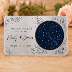 May include: A rectangular silver metal plaque featuring a dark blue circular star map on the right. The text reads THE NIGHT YOU CAME INTO MY LIFE, Emily & James, 07.11.2021, 9:45 PM, BATH. The design includes black line art floral accents and small gold stars.