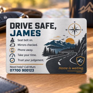 May include: A rectangular brushed metal wallet card featuring the text DRIVE SAFE, JAMES. It includes a compass icon, a mountain road landscape, and a checklist: Seat belt on, Mirrors checked, Phone away, Take your time, Trust your judgement.